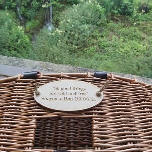 May include: A wicker picnic basket with a wooden plaque attached to the handle. The plaque reads "All good things are wild and free" with the names "Shayna & Ben" and the date "09/06/21".