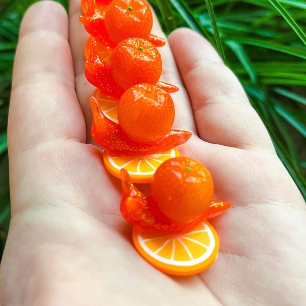 Orange fruit themed snails