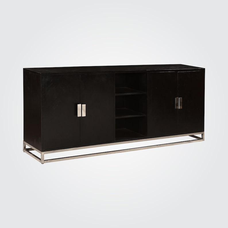 Puede incluir: Un armario de madera negro con detalles en metal plateado y cuatro puertas. El armario tiene tres estantes dentro de la secci&oacute;n central.