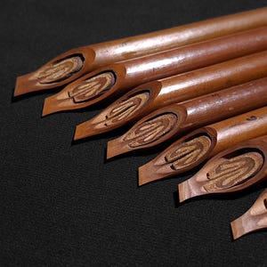 Classic Handam Bili calligraphy tools displayed in close-up studio lighting on a dark backdrop.