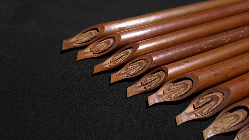 Classic Handam Bili calligraphy tools displayed in close-up studio lighting on a dark backdrop.