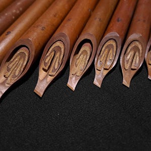 Professional Handam Bili reed pens with angled broad nibs for Arabic calligraphy practice.