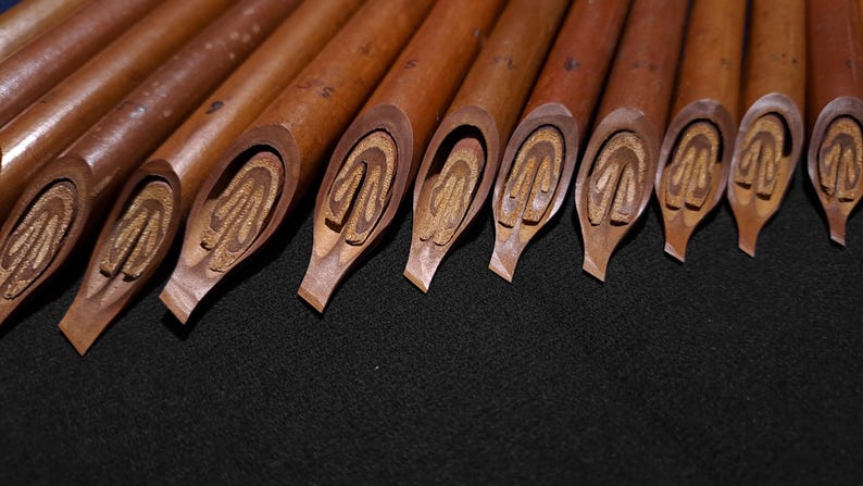 Professional Handam Bili reed pens with angled broad nibs for Arabic calligraphy practice.