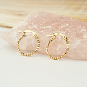 Embrace elegance with our 14K Yellow Gold Beaded Hoop Earrings. Delicate and dainty, these Tiny Bead Huggies are the epitome of Gold Minimalist Earrings. Dainty 14K Gold Hoops designed for women who appreciate timeless beauty.