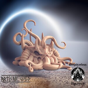 May include: A 3D printed miniature of a monstrous creature with a skull-like head and tentacles. The creature is painted in a light brown color and is sitting on a gray surface. The image is labeled "Kingdomless Figurines".