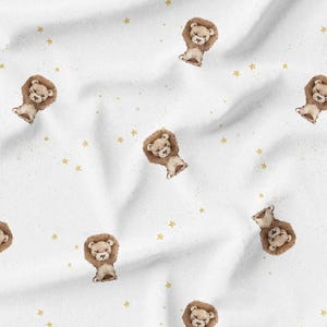 May include: White fabric with a repeating pattern of watercolor lion illustrations and gold stars. The lions have brown manes and are in a seated position. The stars are small and scattered across the fabric.