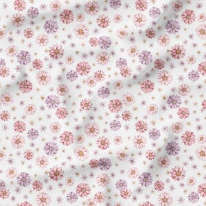 May include: White fabric with a repeating pattern of watercolor-style flowers in shades of pink, purple, and peach. The flowers vary in size and are scattered across the surface, creating a delicate, floral design.