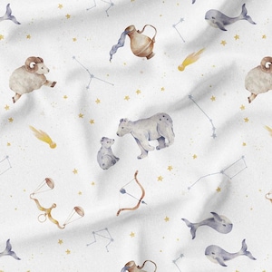 May include: White fabric with a repeating pattern of watercolor illustrations. The design includes zodiac symbols like Aries, Libra, and Sagittarius, along with whales, bears, and constellations. Gold stars and shooting stars are scattered throughout.