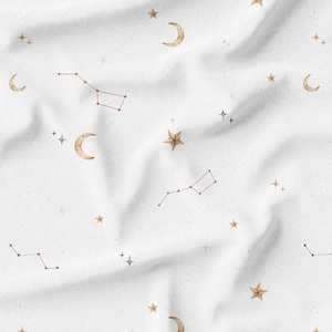 May include: White fabric with a celestial pattern featuring gold stars, crescent moons, and constellations. The design includes various sizes of stars and moons, with constellations depicted as connected lines. The fabric has a soft, textured appearance.