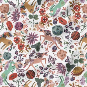 May include: A whimsical fabric pattern featuring unicorns, planets, and flowers in shades of brown, pink, green, and purple on a white background. The design includes various floral elements and celestial bodies.