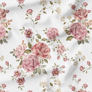 May include: A white fabric with a repeating floral pattern. Large pink roses, smaller pink flowers, and delicate white blossoms are scattered across the surface, with green leaves and stems.