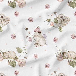 May include: White fabric with a repeating watercolor pattern of bunnies, flowers, bees, and leaves. The bunnies are light brown and the flowers are pink and purple. The bees are black and yellow.