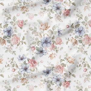 May include: White fabric with a watercolor floral pattern. The design features clusters of pink roses, blue and peach-colored flowers, and green leaves. The fabric has a soft, flowing appearance.