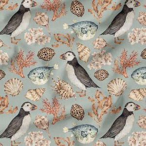 May include: A repeating pattern featuring watercolor illustrations of puffins, seashells, coral, and sea urchins on a light teal background. The puffins are black, white, and gray with orange beaks. The seashells are beige and the coral is orange.