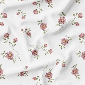 May include: White fabric with a repeating floral pattern. The design features watercolor-style pink flowers with yellow centers and green leaves. The flowers are arranged on delicate stems.