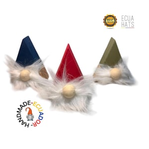 May include: Three gnome hats in blue, red, and olive green with white faux fur beards and wooden noses. The hats are triangular and have a rustic, handmade appearance. The image includes the text "ECUA HATS" and "BEST SELLER".