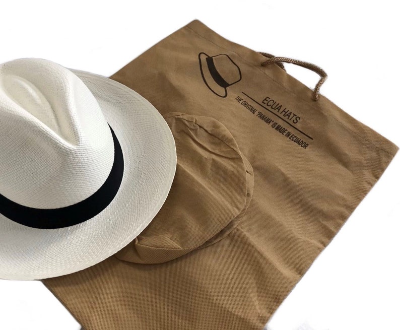 May include: A white Panama hat with a black band, packaged in a brown canvas bag with the text "Ecua Hats The Original Panama is Made in Ecuador".