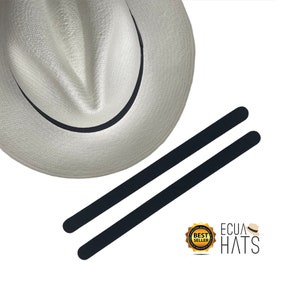 May include: A white Panama hat with a black band and two black hatband strips. The hat is made of woven material. The image also includes a "Best Seller" badge and the text "ECUA HATS".