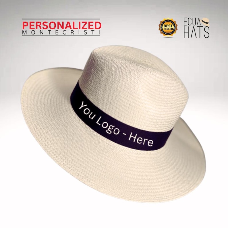Puede incluir: Un sombrero de paja blanco con una banda negra que dice "You Logo - Here". El sombrero es de estilo cl&aacute;sico con un ala ancha y una corona ligeramente puntiaguda.