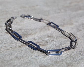 May include: A silver chain necklace with a simple, linked design. The chain is made of oval-shaped links.