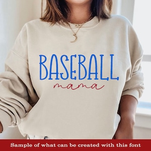 May include: A beige sweatshirt with the text "BASEBALL mama" in blue and red lettering.