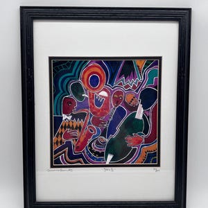 May include: A framed art print titled Jazz III featuring a colorful, abstract illustration of musicians playing instruments including a saxophone, trumpet, and double bass. The artwork uses bold lines and vibrant shades of blue, red, and orange.