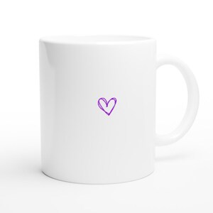May include: White ceramic mug with a purple heart drawn on the front.
