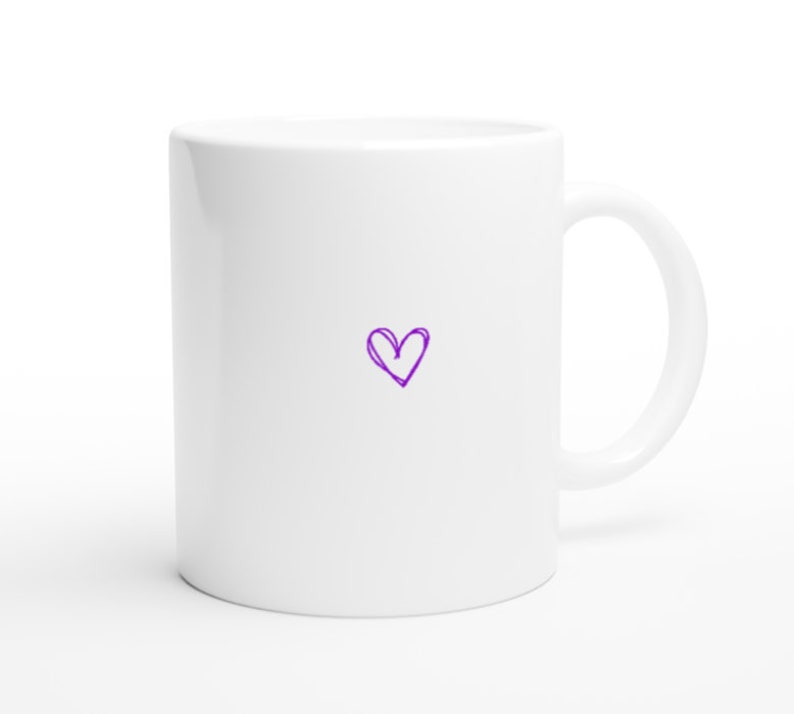May include: White ceramic mug with a purple heart drawn on the front.
