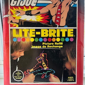 May include: A Lite-Brite Picture Refill box featuring a G.I. Joe character on the front. The box includes 12 Lite Brite pictures and 24 guide sheets to create your own designs.
