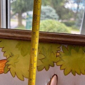 May include: A yellow measuring tape with black markings and red numbers. The tape is extended to 21 inches and shows the numbers 1-315, 1-416, 1-517, 1-618, 1-719, 1-820, 1-921, 50, 1, 2, 3, 4, and 5.