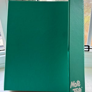 May include: A teal green binder with a matching teal green Note Tote label on the side.