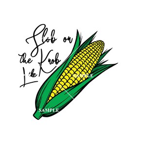 May include: A green and yellow corn on the cob with the text "Slob on the Krob like" written in black cursive.