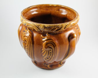 Antique Unmarked McCoy Six inch brown/yellow Jardinière with a cool Art Nouveau abstract chicken head pattern.  Can't find anything like it!