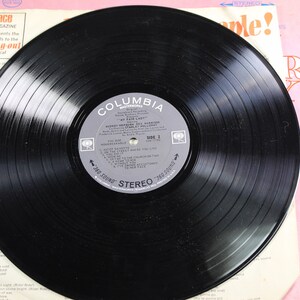 May include: A black vinyl record with a Columbia Records label. The label features the title "My Fair Lady" and the song titles "Wouldn't It Be Loverly" and "I Could Have Danced All Night".