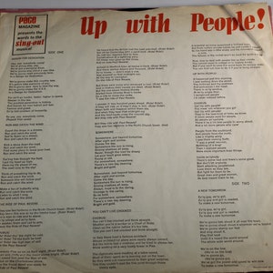 May include: A vintage record album cover with a red, white, and blue color scheme. The album is titled "Up with People!" and features lyrics from the musical. The cover includes a photo of a group of people singing and dancing.