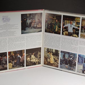 May include: A vintage record album cover for the musical "My Fair Lady". The cover features a collage of images from the musical, including scenes from the play and portraits of the actors. The album cover is in a pink and white color scheme.