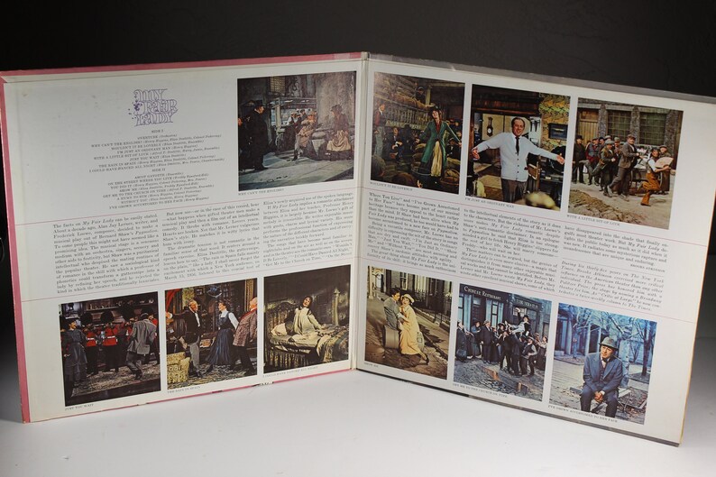 May include: A vintage record album cover for the musical "My Fair Lady". The cover features a collage of images from the musical, including scenes from the play and portraits of the actors. The album cover is in a pink and white color scheme.
