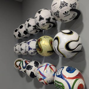 May include: A set of three ceramic mugs with a speckled, matte finish. The mugs are in shades of cream, light gray, and dark gray. Each mug has a simple, minimalist design and a rounded handle. Perfect for coffee or tea.