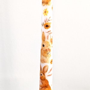 Easter Taper Candles with Easter Bunny and Egg in hand with Sunflowers.