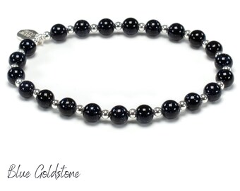 May include: A blue goldstone bracelet with silver beads. The bracelet is made of natural stones and is a beautiful and unique piece of jewellery.