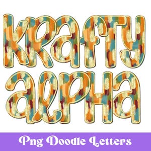 May include: Krafty Alpha in colorful, brushstroke-style letters with gold accents.  The letters are outlined in gold and have a textured, painted look.  The letters are set against a white background.
