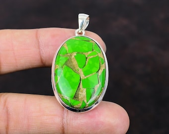 May include: A silver pendant with a green and gold oval gemstone. The gemstone has a cracked and textured surface.