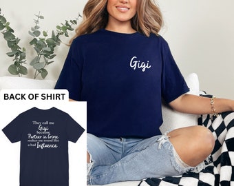 May include: A navy blue t-shirt with the text "Gigi" embroidered on the front and the text "They call me Gigi because Partner in Crime makes me sound like a bad Influence" on the back.