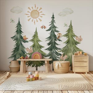 Può includere: Una scena stravagante di cameretta con un murale di alberi ad acquerello, sole, nuvole e creature del bosco. Una panca in legno ospita un arcobaleno e veicoli giocattolo. Un tappeto rotondo, un cesto intrecciato e una cassettiera in legno completano l'arredamento.