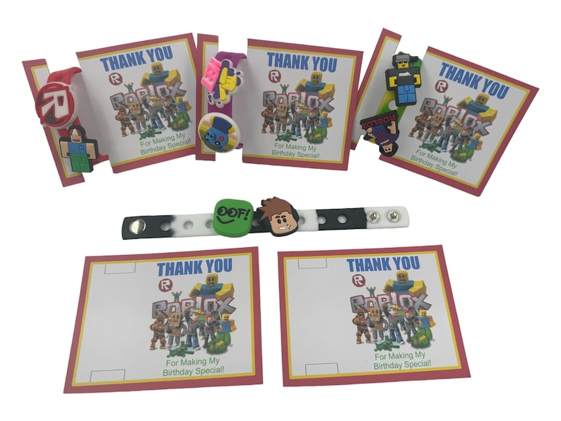 May include: A set of six Roblox-themed thank you cards with a red and white border. Each card features a different Roblox character and the text "Thank You" and "For Making My Birthday Special!" in red and white text. The cards are accompanied by a black and white silicone bracelet with a Roblox character charm.