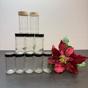 clear round glass jars with black and white lids, various storage purposes, kitchen spice jars, airtight jar, salt and pepper storage.