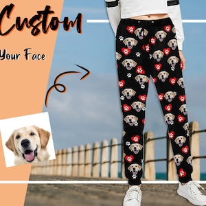 May include: Black sweatpants with a repeating pattern of a dog's face and red hearts. The text "Custom Your Face" is visible in the image.