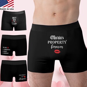 May include: Black boxer briefs with various white text designs. One pair says "BEST SEX ON Susan", another says "TO DO: 1. ANGELICA 2. REST 3. REPEAT", and a third says "PROPERTY OF Susan" with a red lip graphic. The fourth pair says "Maria's PROPERTY forever" with a red lip graphic.