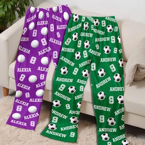 May include: Two pairs of personalized pajama pants. One pair is purple with white volleyballs, the name "Alexia", and the number 8. The other pair is green with soccer balls, the name "Andrew", and the number 9.