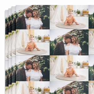 May include: A collage of photographs featuring a couple and their baby. The couple are dressed in formal attire, whilst the baby is wearing a peach-coloured onesie. The photographs are set against a backdrop of greenery and a white teepee.